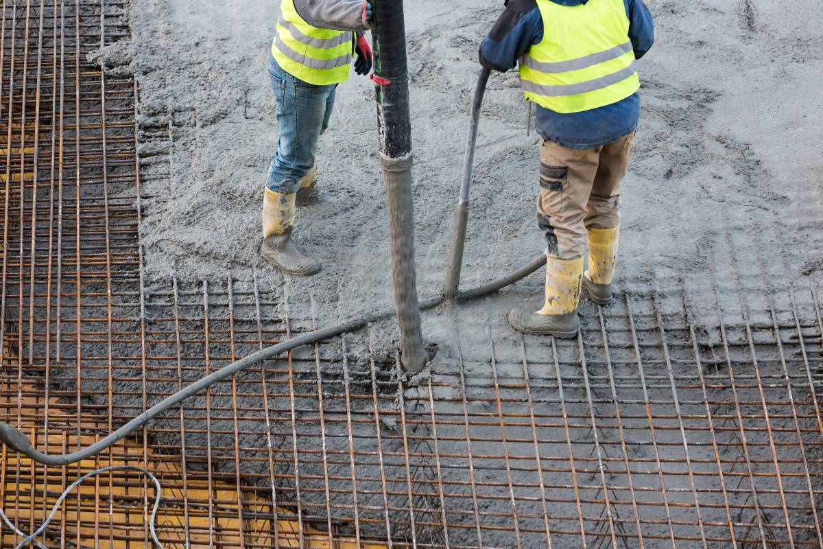 Two construction workers performing cold weather concreting