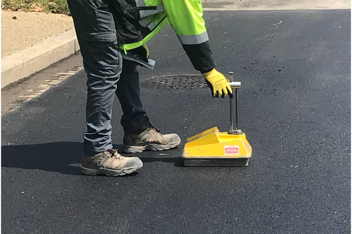 Construction worker using a nuclear density gauge