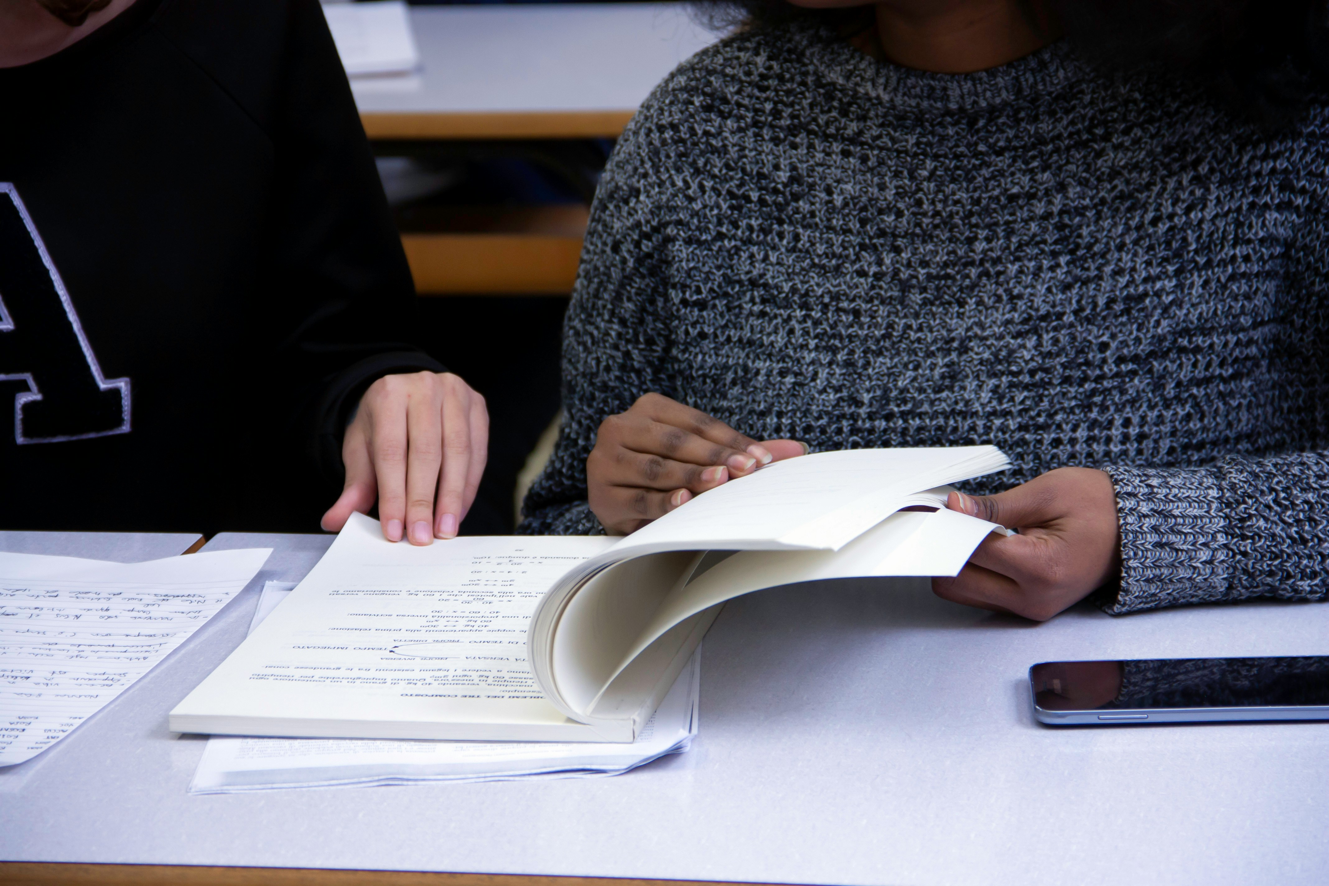 Two people sitting at a table reviewing training materials