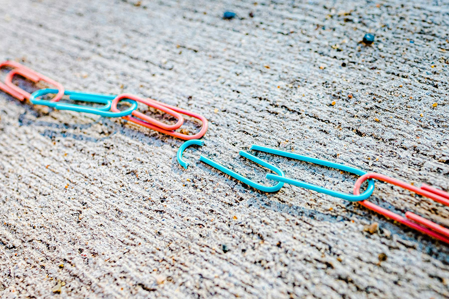 chain of paperclips on a concrete surface