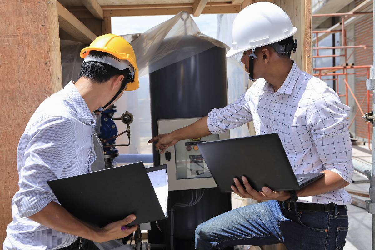 Construction inspector conducting fireproofing inspection with clipboard