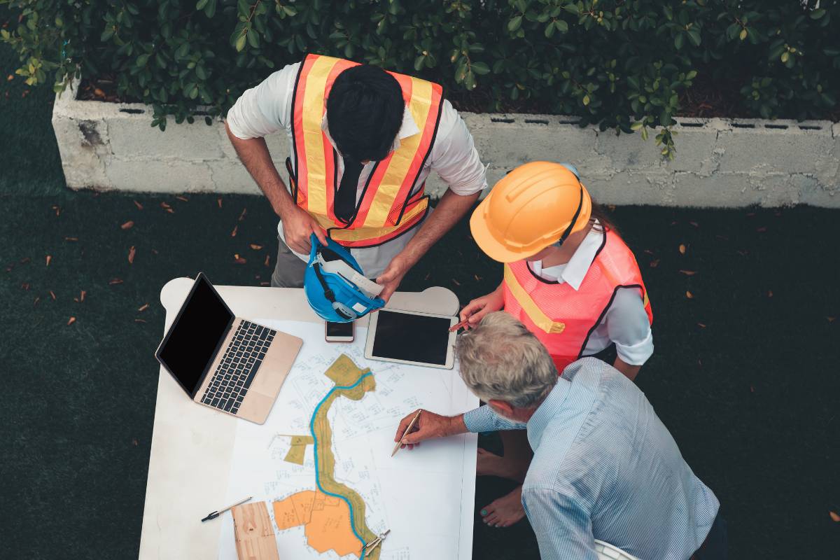 2 construction workers and project manager working on construction project