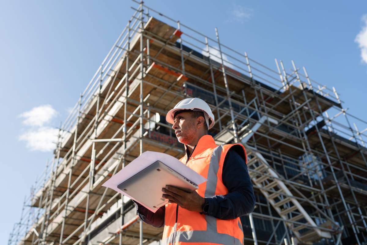 Geotechnical professional with laptop on active job site