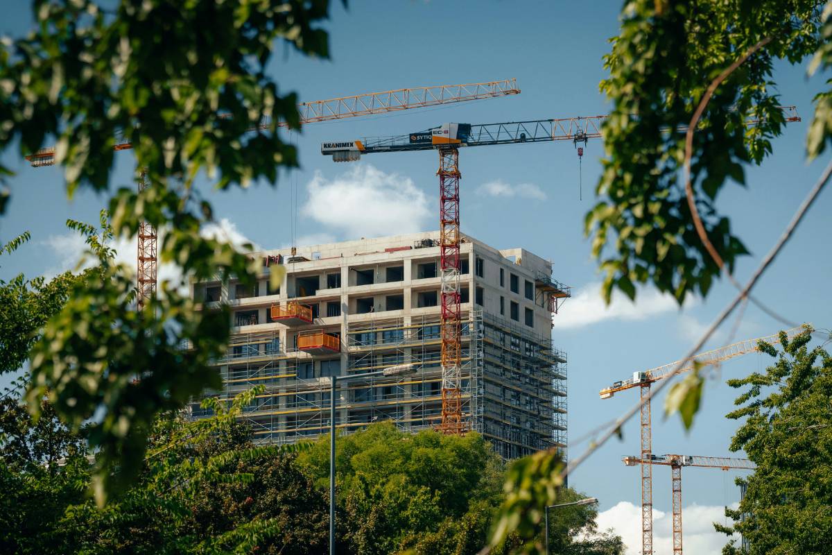 Construction site with multiple tower cranes working on multi-story building project