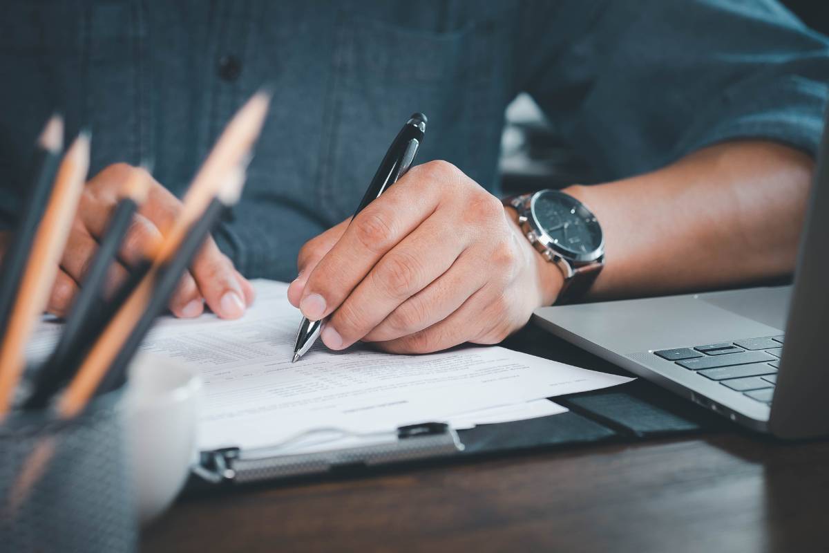 Man filling out questionnaire at a desk